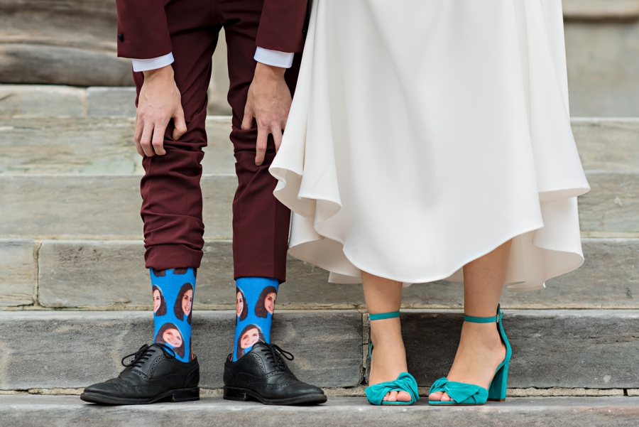 A bride in blue shoes and a groom in funny socks.